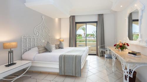 A bed or beds in a room at Djerba Aqua Resort