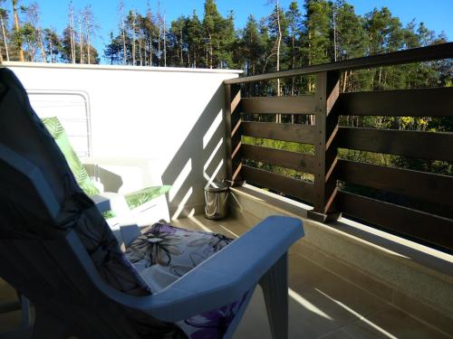 einem blauen Stuhl auf dem Balkon eines Hauses in der Unterkunft Nikol Deluxe in Welingrad