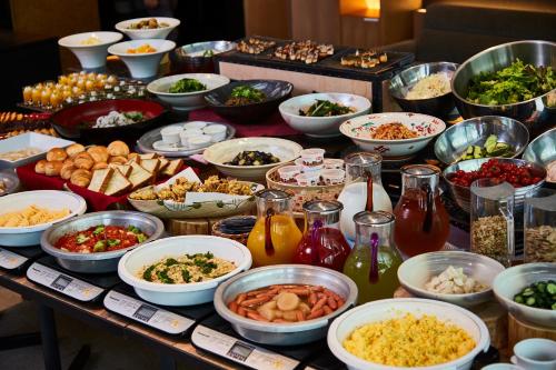 a buffet with many bowls of food on a table at Kyoto Granbell Hotel in Kyoto