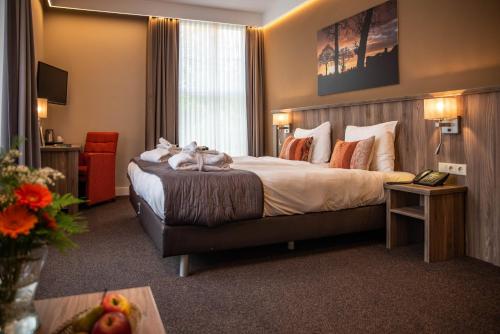 מיטה או מיטות בחדר ב-Landgoed Hotel & Restaurant Carelshaven