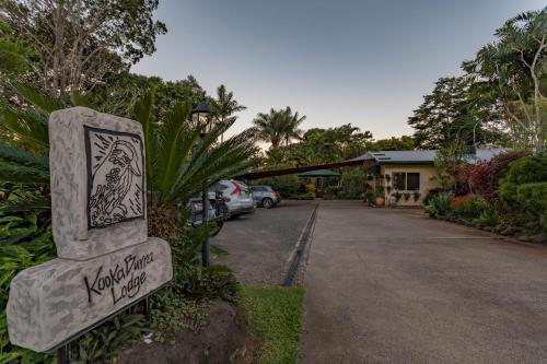 a sign for a house with a parking lot at Kookaburra Motel Yungaburra in Yungaburra