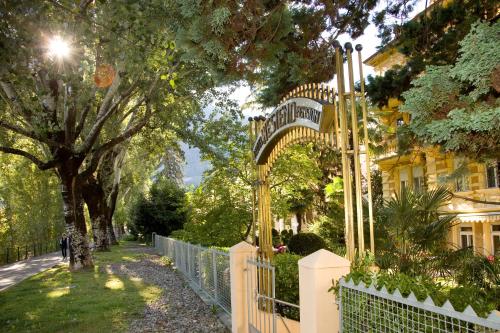 una recinzione con un cancello di fronte a una casa di Hotel Villa Westend a Merano