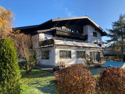 ein weißes Haus mit schwarzem Dach in der Unterkunft Appartements Klausner in Altenmarkt im Pongau