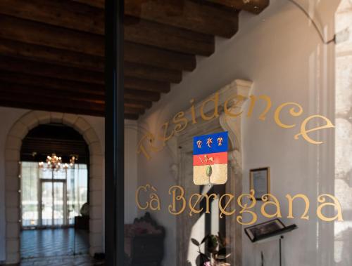 a sign for the entrance to a building with a flag at Residence Cà Beregana in Vicenza