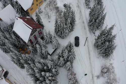 兰卡Altitude Guest House Ranca的雪中房屋的空中景观