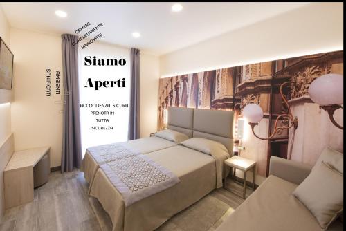 a bedroom with a bed and a sign on the wall at Hotel Sempione in Milan