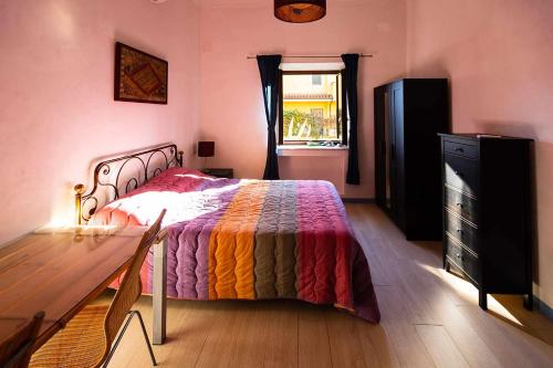 a bedroom with a bed and a dresser and a window at Appartamento Villa Matone in Grottaferrata