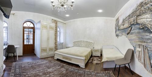 a bedroom with a bed and a table and chairs at Апартаменти в Старому Місті Sweet House in Kamianets-Podilskyi