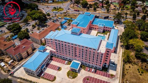 an overhead view of a large building with blue roofs at Golden Peacock Hotel Blantyre in Blantyre