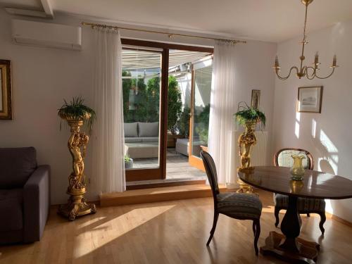 a living room with a table and chairs and a couch at Amadeus Apartment in Baden