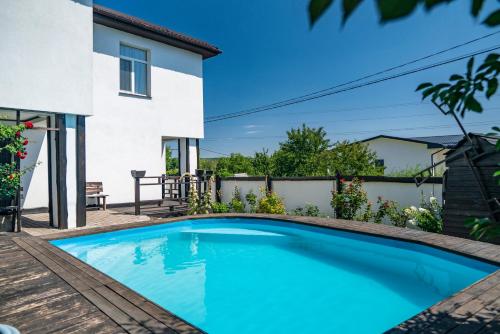 a swimming pool in front of a house at Dniprovskiy Dvir in Dnipro