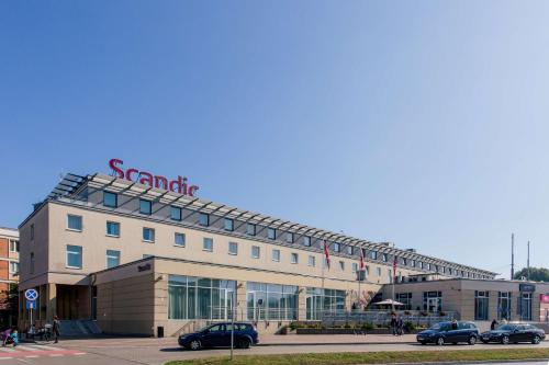 a large building with a sign on top of it at Scandic Gdańsk in Gdańsk