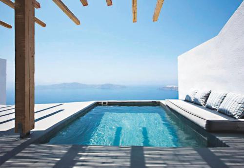 a swimming pool with a view of the ocean at Remezzo Villas in Imerovigli