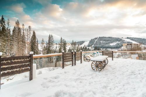 a carriage in the snow on a fence at MK Resort (ex. Magiya Karpat) in Bukovel