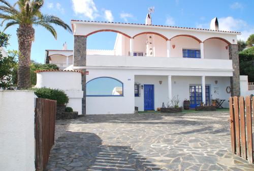 una casa con una palma di fronte di Es Caials a Cadaqués