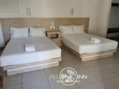 En eller flere senger på et rom på Pelicano Inn Playa del Carmen - Beachfront Hotel