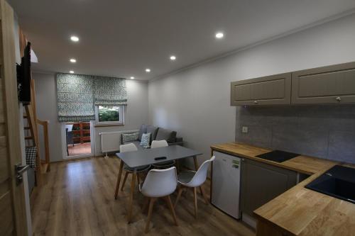 a kitchen with a table and a table and chairs at Auto-Camping Park in Jelenia Góra