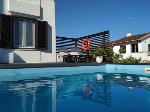 a swimming pool in front of a building with a house at GAETA - Villa Fontania in Gaeta