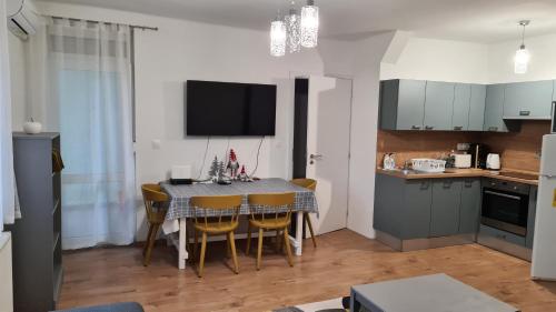 een keuken en eetkamer met een tafel en stoelen bij Pelso apartman in Keszthely