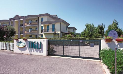 una valla frente a una casa con pista de tenis en TIGLI Lido Altanea, en Caorle