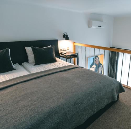 a bedroom with a large bed and a window at Brother House Kaunas in Kaunas