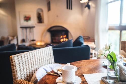 a wooden table with a coffee cup on top of it at Landhotel Villa Foresta in Braunlage