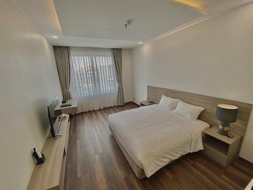 เตียงในห้องที่ Mansion Park Hotel & Apartment