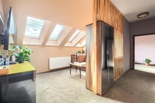 an office with skylight ceilings and a room with a desk at Weranda Apartments in Morzyczyn