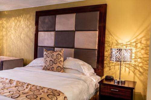 a bedroom with a bed with a large headboard at Gateway Inn and Suites in Salida