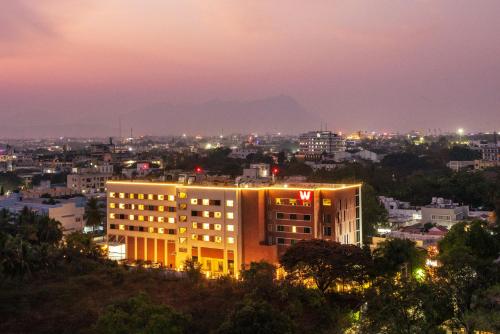 a building with a view of a city at night at Welcomhotel by ITC Hotels, RaceCourse, Coimbatore in Coimbatore