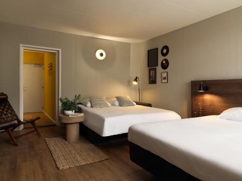 Tempat tidur dalam kamar di Townhouse Apartments Maastricht