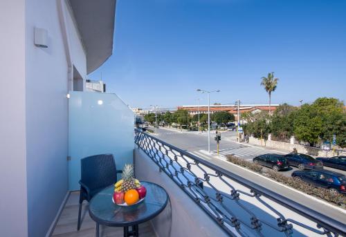 a balcony with a table and a view of a street at Stoa Suites Chania in Chania Town