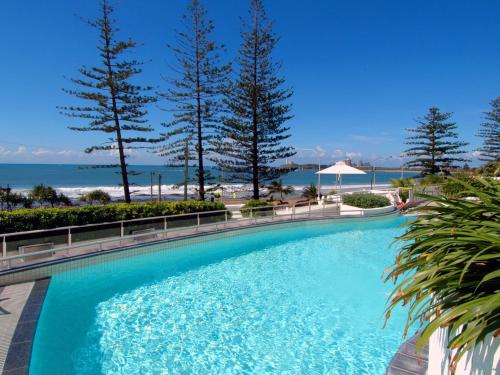 a swimming pool with a view of the beach at Sirocco 202 in Mooloolaba