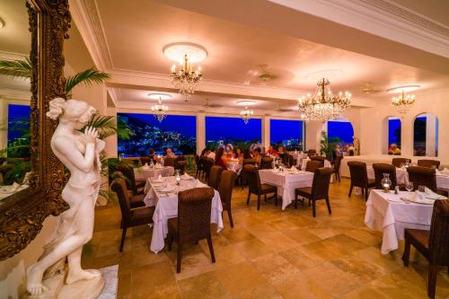 a restaurant with a statue of a woman in a mirror at Casa Kimberly Boutique Hotel in Puerto Vallarta