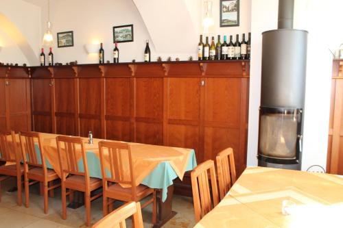 a dining room with a table and some bottles of wine at Landgasthof Heerlein in Bamberg