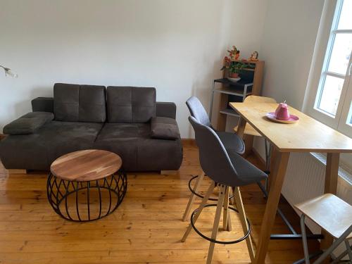 a living room with a couch and a table at Ferienwohnungen Jakobsberg in Bamberg