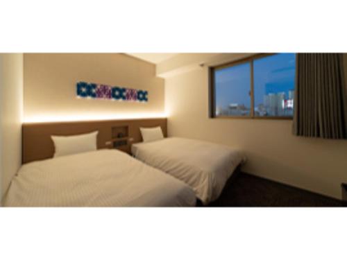 Tempat tidur dalam kamar di R&B Hotel Nagoya Ekimae - Vacation STAY 15188v