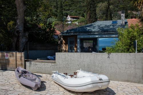 a couple of boats sitting on the ground in front of a house at Spa Villa Skaloma in Nafpaktos