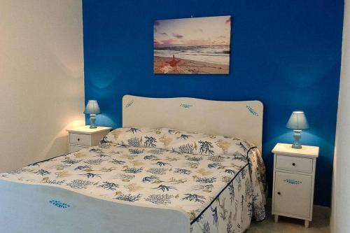 a bedroom with a bed with a blue wall at A Casa di Margy in Ravello