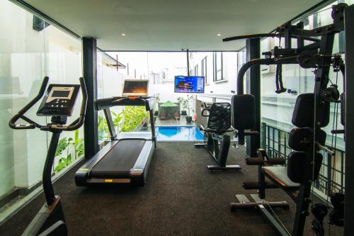 a gym with treadmills and a treadmill at Sutasoma Hotel in Jakarta