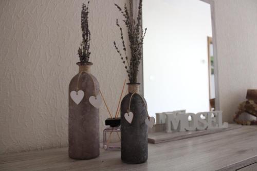 two vases with hearts on them sitting on a table at Bachmeier's Gasthaus Traube Niederfell in Niederfell