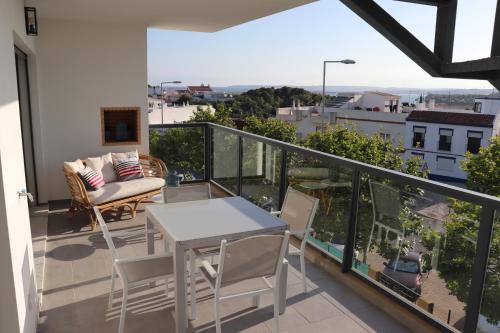 a balcony with a table and chairs and a view at ROOF TOP SEA VIEW ALVOR in Alvor