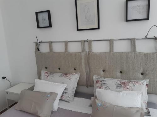 a room with pillows and a bed with a headboard at Apartments Kule in Brela