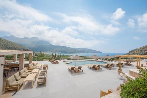 a resort with a pool and tables and chairs at Brazzo di Maina in Oítilon