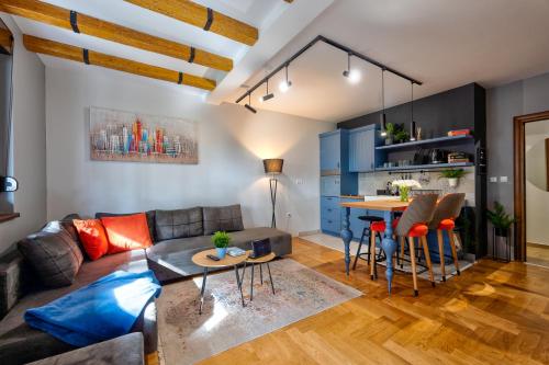 a living room with a couch and a table at Apartment ERAK HILL in Zlatibor