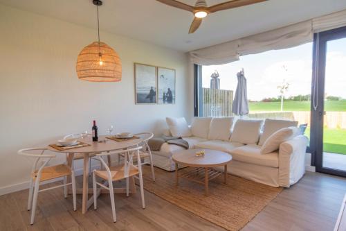 a living room with a couch and a table at OCEANSUITESLANGRE in Galizano