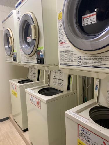 a group of washers and dryers in a store at Smile Hotel Nagoya Sakae in Nagoya