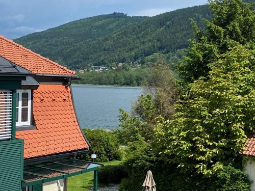 a view of a lake from a house at FeWo mit Seeblick in Bodensdorf