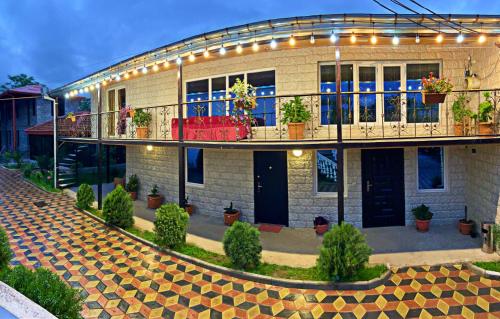 a building with a lot of potted plants on it at Hotel Doko in Martvili