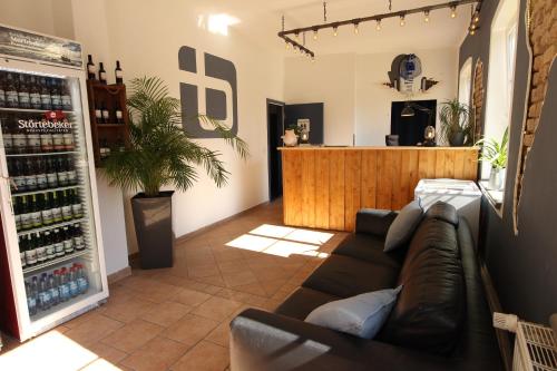 a living room with a couch and a bar at Blue Doors Hostel KTV in Rostock